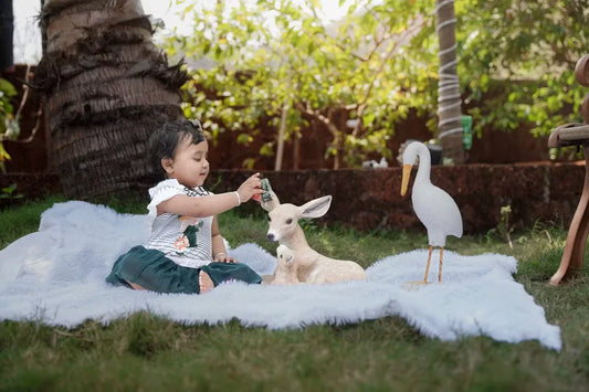 baby playing with animals