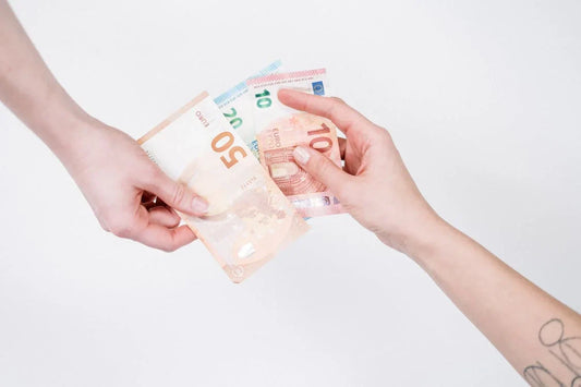 deux mains échangent des billets d'argent